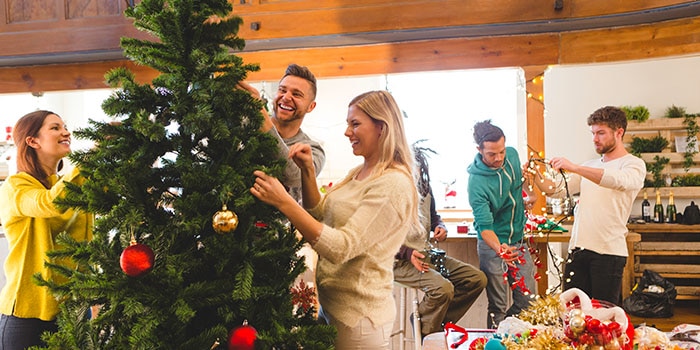 Image of people decorating a Christmas tree