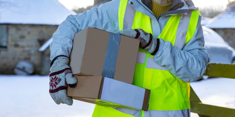 Image of delivery driver holding packages
