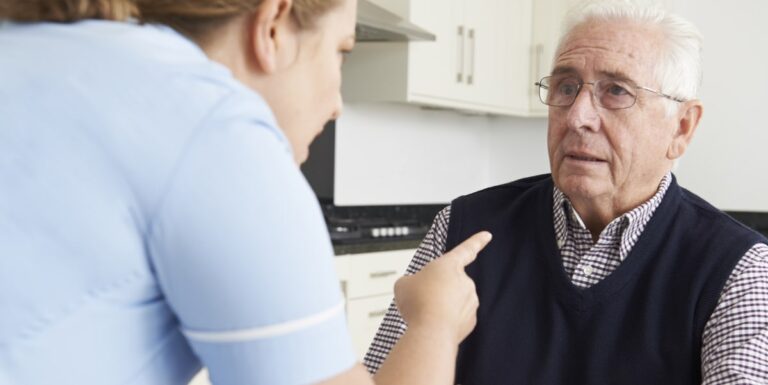 Image of a nurse yelling at an elderly man