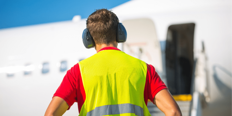 Image of an airport worker wearing heavy ear protection
