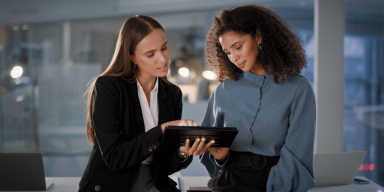 Image of two women looking at some information on a tablet