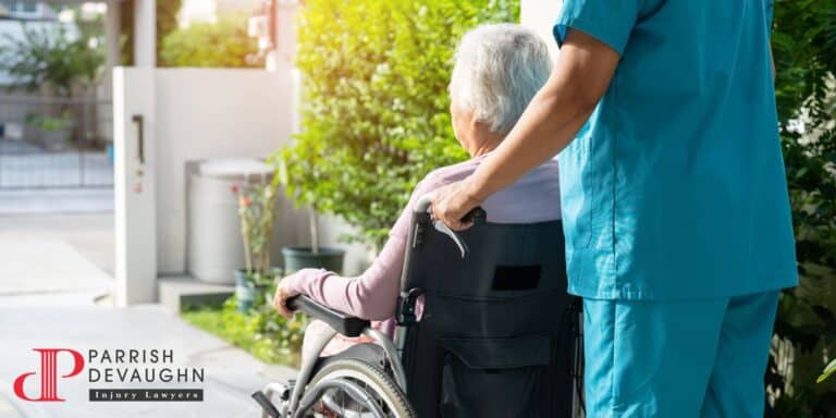 Image of a nurse pushing an elderly person in a wheelchair
